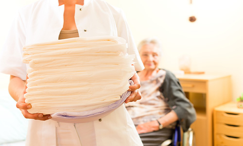 Cuidadora sostiene pañales para la incontinencia fecal